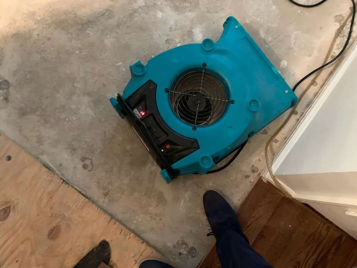 Air mover drying subfloor during Leak Detection & Repair in Waukesha